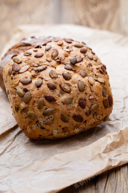 Preview: Bread background, top view of, black and rye loaves on black.