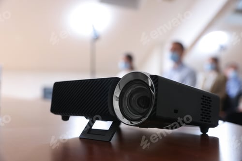 Preview: Modern video projector on table during conference