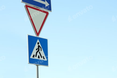 Preview: Post with Pedestrian Crossing and other traffic signs in city on sunny day