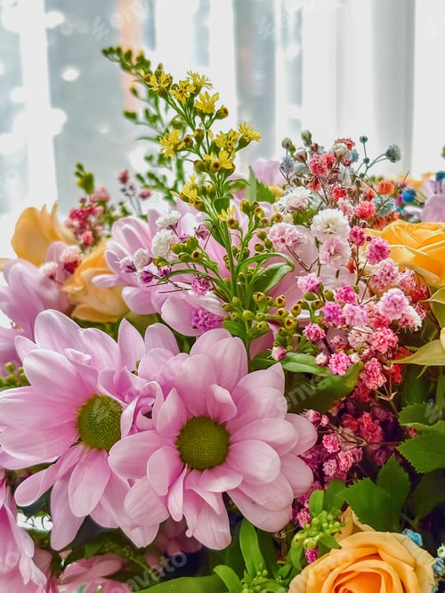 Preview: Beautiful spring flower bouquet with pink chrysanthemums, yellow solidago, and gypsophila