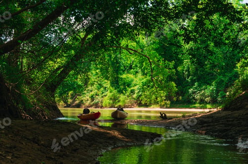 Preview: Kayaks parked on a river bank during the adventure