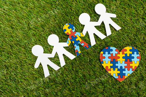Preview: Top view of special kid with autism among another and decorative heart on green background
