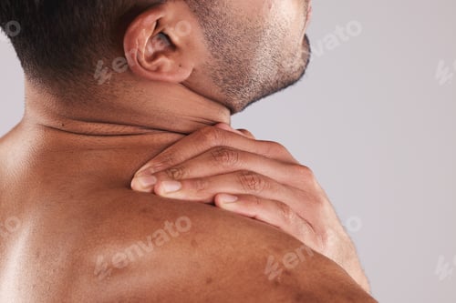 Preview: Muscular man hand holding her neck pain, hurt and body injured problem in studio. Male model from b