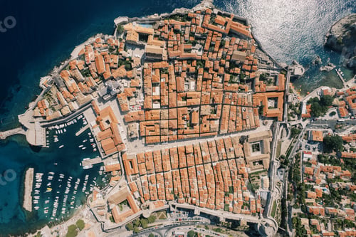 Preview: Red roofs of ancient houses in the port with moored boats. Dubrovnik, Croatia. Drone