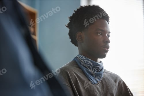 Preview: Black Teenage Boy Attending Counseling Session in Bright Modern Office