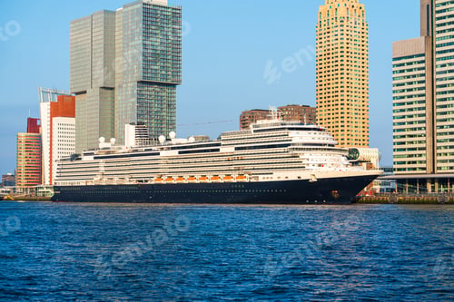 Preview: Big cruise ship parked in center of rotterdam. View of the skyscrapers of rotterdam on a sunny day