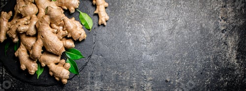 Preview: Fresh ginger with leaves on a stone board.