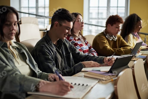 Preview: Diverse Group of University Students Taking Notes during Lecture in Classroom