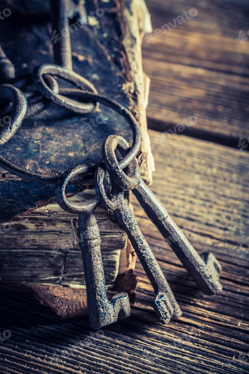 Preview: Aged keys and books on old wooden table