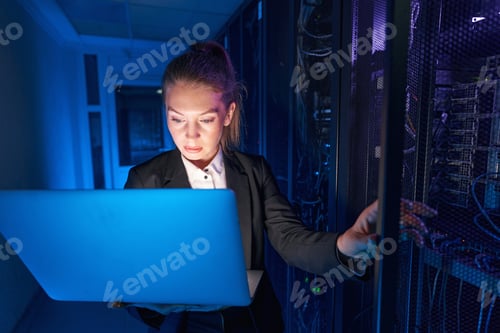 Preview: System technician using laptop to analyze server