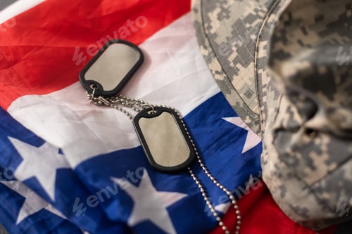 Preview: Army tokens on military uniform and USA national flag background.