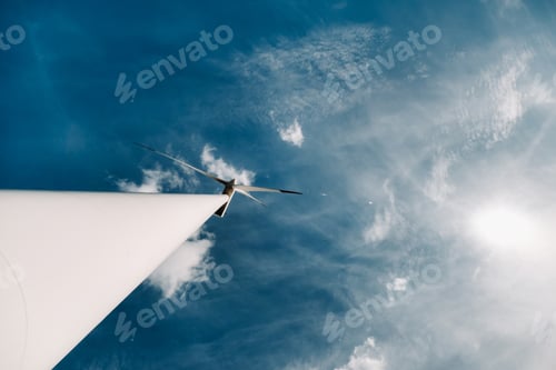 Preview: A white Windmill against a blue sky. Windmill in nature