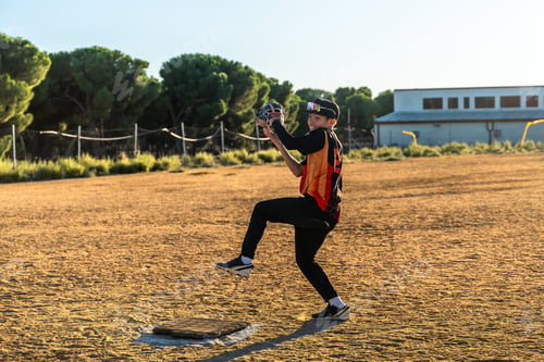 Preview: Young baseball pitcher throwing ball from mound