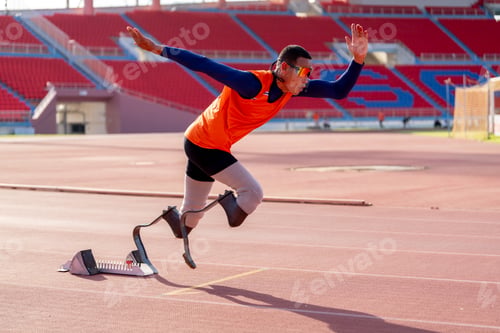 Preview: Asian para-athletes with prosthetic blades sprint on a running track at stadium.