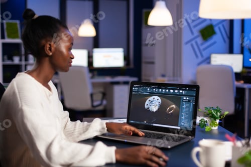 Preview: Black woman in mechanical industry working late at night doing overtime