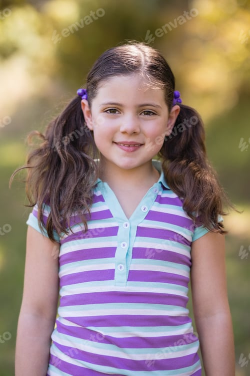 Preview: Smiling little girl standing in forest