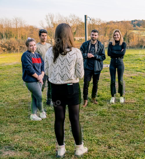 Preview: Young woman in white sweater thanking her friends for preparing a birthday party for her