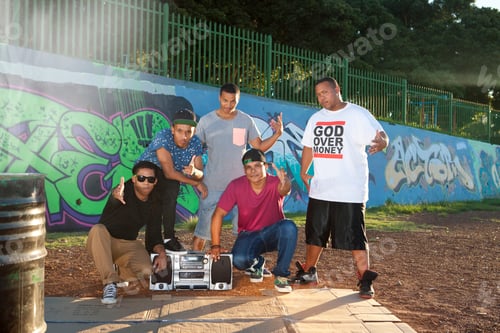 Preview: Portrait of five male hip hop dancers in park at dusk