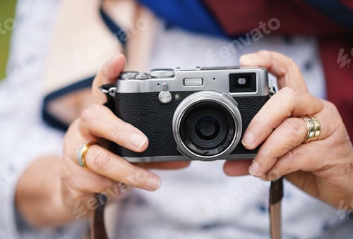 Preview: Old woman hands holding camera taking photo