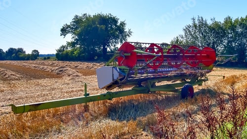 Preview: Harvester machine harvesting fresh crops on a farm field during a sunny day