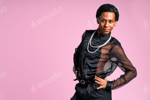 Preview: Fashionable fluid gender man posing in studio