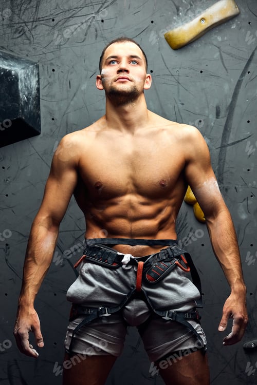 Preview: Portrait of cheerful rock climber in indoor climbing gym