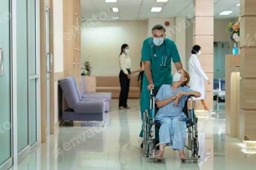 Preview: Senior man doctor take care elderly woman patient sitting on a wheelchair at hospital.