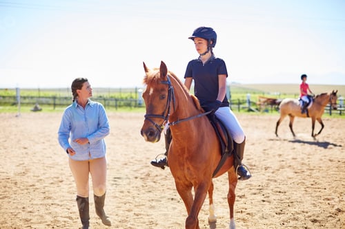 Preview: Coach and girl on horse on riding ring