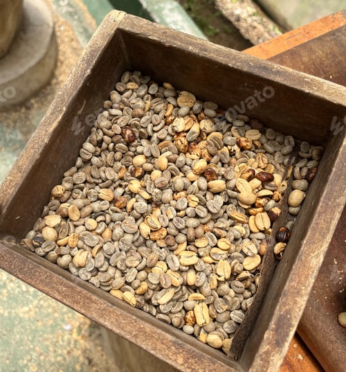 Preview: Food background with Green unroasted coffee beans in old wooden box. Top view.