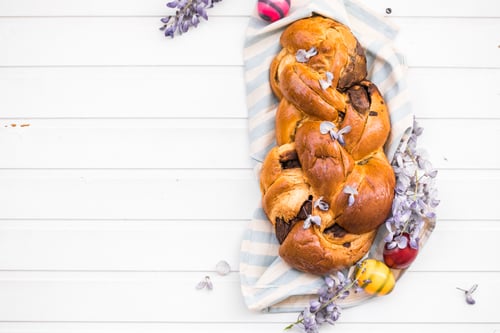 Preview: Tsoureki traditional baked Greek Easter sweet bread. top view, flat lay, copy space