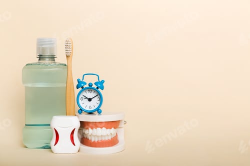 Preview: Mouthwash and other oral hygiene products on colored table top view with copy space.