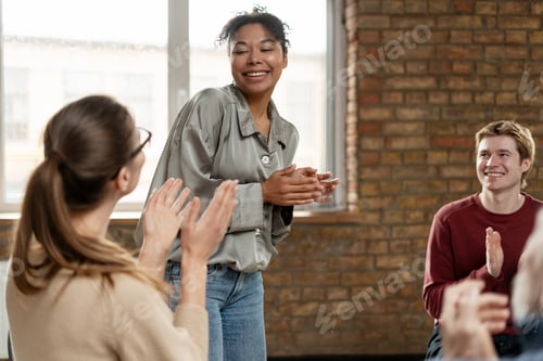 Preview: Diverse Team Clapping to Coworker after Successful Presentation in Office