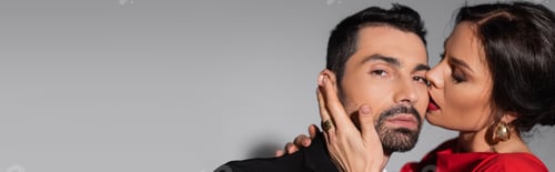 Preview: Sensual woman kissing bearded boyfriend on grey background, banner