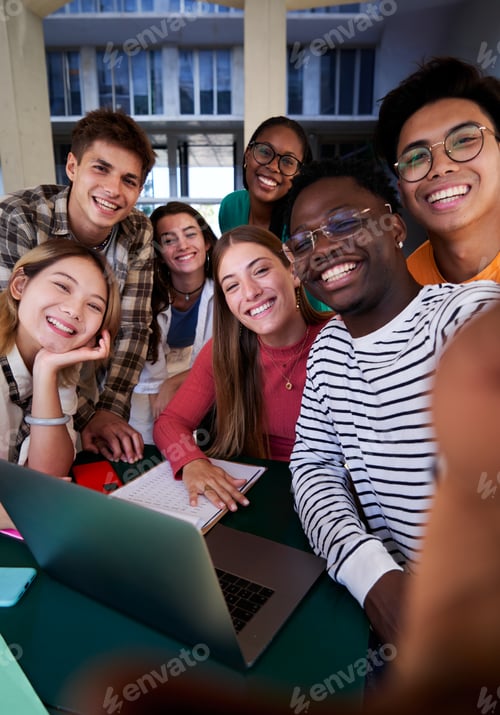 Preview: Happy selfie of a multiracial group of student friends gathered at university studying.
