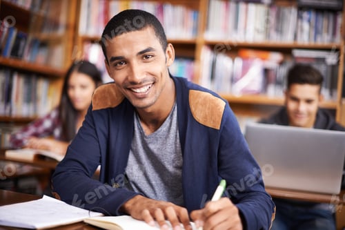 Preview: Cropped portrait of a handsome young student working diligently in his classroom