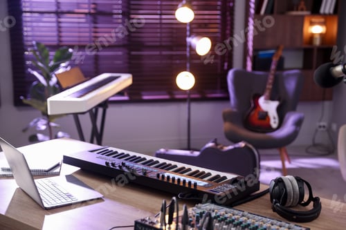 Preview: MIDI keyboard, laptop and headphones on wooden table in home studio