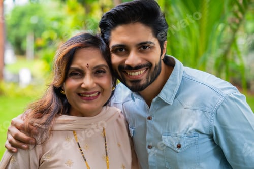 Preview: Indian mother son share smiles in their home garden, enjoying a loving and joyful moment togetheer