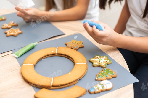 Preview: Children decorated Christmas gingerbread cookies on the table