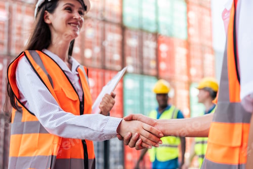 Preview: Close up of Business male and female shake hand in container terminal.