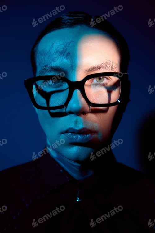 Preview: Handsome young man captures attention with stylish glasses and striking lighting in a modern setting