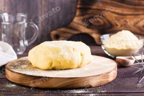 Preview: Ready raw dough for baking mexican tortillas on the board on the table. Homemade pastries