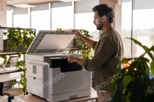 Preview: Office worker using multifunction printer in the office