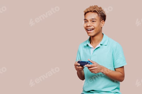 Preview: Cheerful afro latin american young boy playing video game with controller