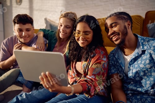 Preview: Multiracial group of happy friends taking selfie with touchpad at home.