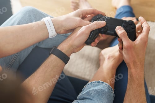 Preview: Couple with a gamepads are playing video game console