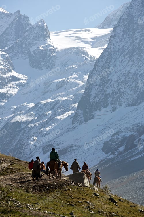 Preview: Travelers on horseback journeying through mountainous terrain