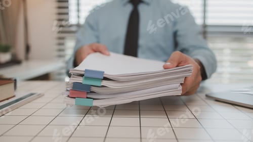 Preview: a businessman is handling documents in the office, an accountant is collecting documents