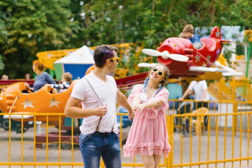 Preview: Young Happy Couple in Love Walks and has Fun in an Amusement Park