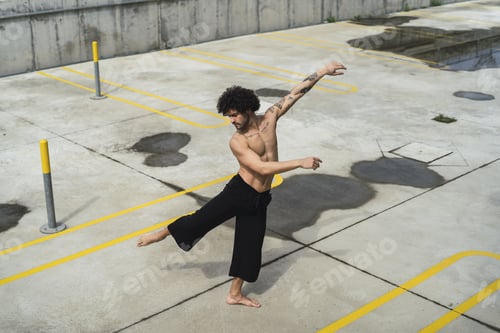 Preview: Half-naked athletic European guy with tattoos exercising outdoors
