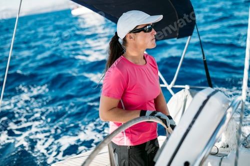 Preview: Happy strong woman sailing with her boat